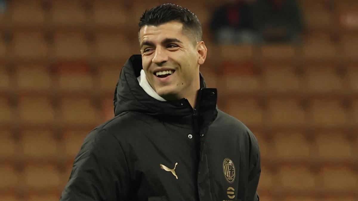 Milan striker Alvaro Morata smiles in his trauning gear on the pitch ahead of a game